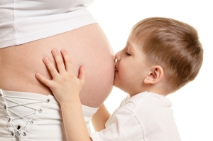 boy-kisses-pregnant-womans-
